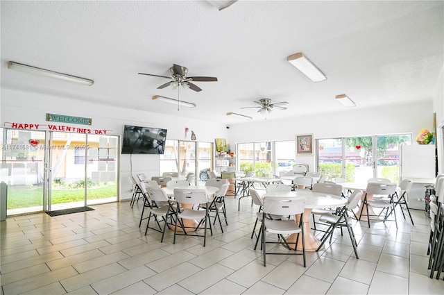 dining space featuring ceiling fan, plenty of natural light, and a textured ceiling