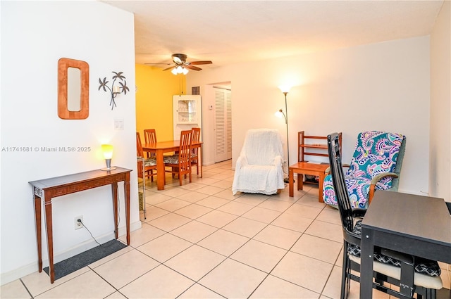 interior space featuring light tile patterned floors and ceiling fan