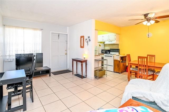 tiled living room with ceiling fan