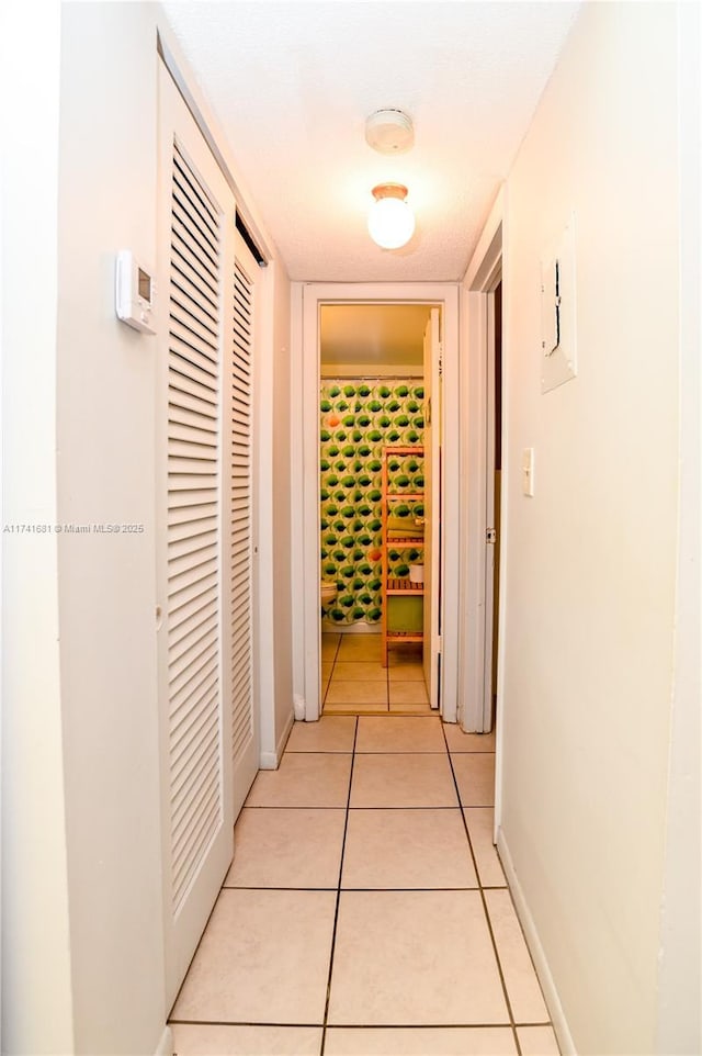 hallway featuring light tile patterned floors