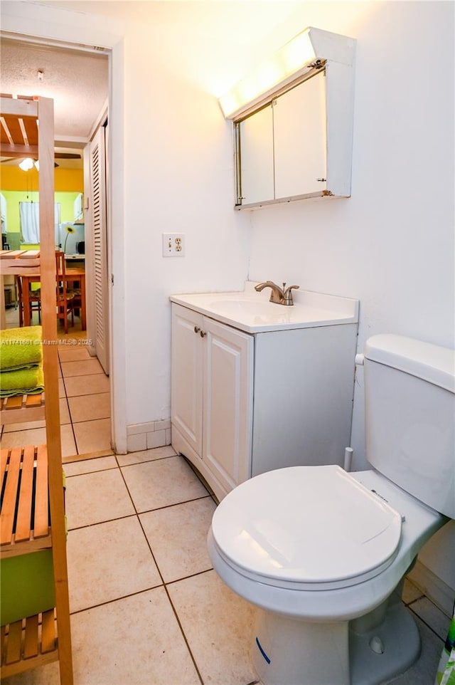 bathroom with vanity, tile patterned floors, and toilet