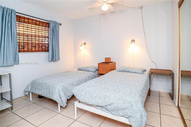 tiled bedroom featuring ceiling fan