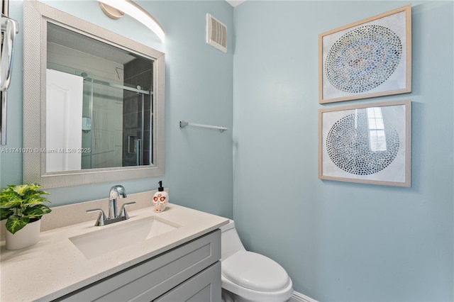 bathroom with walk in shower, vanity, and toilet