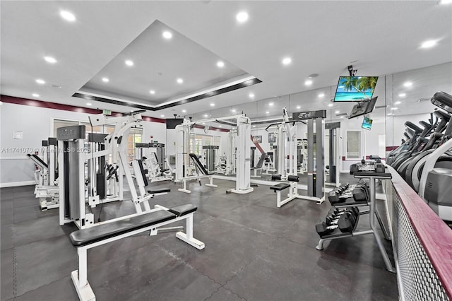 gym featuring a tray ceiling