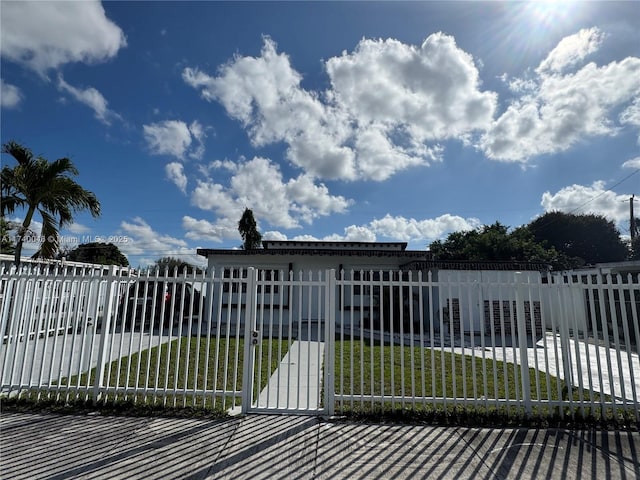 view of gate featuring a yard