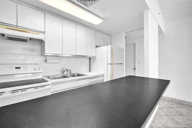 kitchen featuring white appliances, sink, and white cabinets