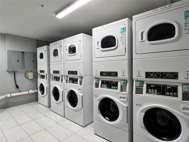 washroom with electric panel, stacked washer and clothes dryer, and washing machine and clothes dryer