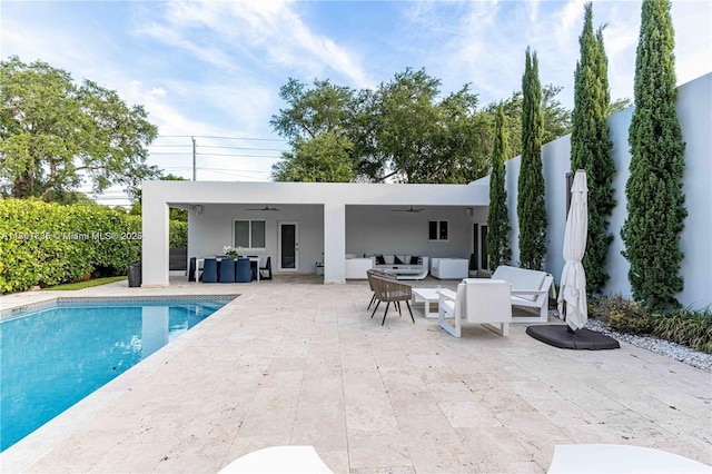 view of swimming pool with an outdoor living space, a patio, and ceiling fan