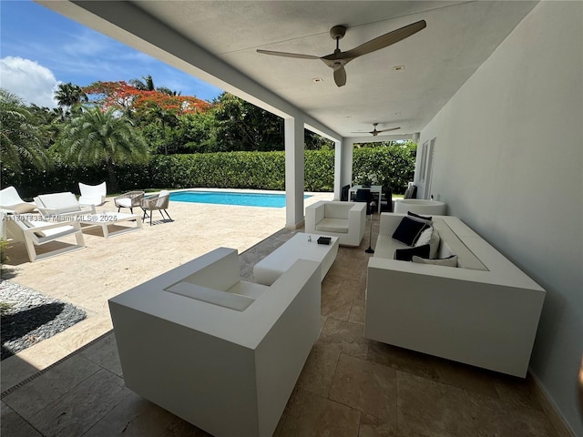 view of patio / terrace with a fenced in pool, an outdoor living space with a fire pit, and ceiling fan