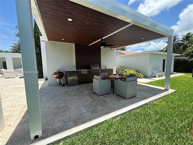 view of patio with an outdoor kitchen, a grill, and ceiling fan