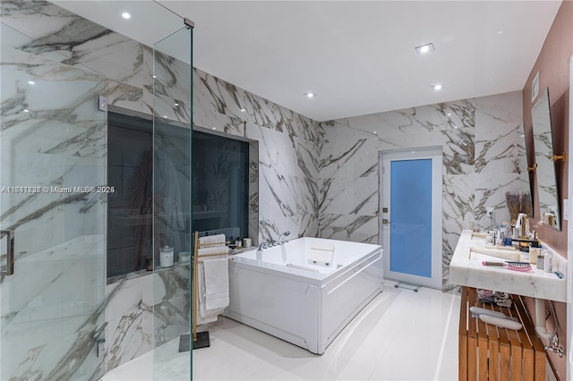 bathroom featuring vanity, plus walk in shower, and tile walls