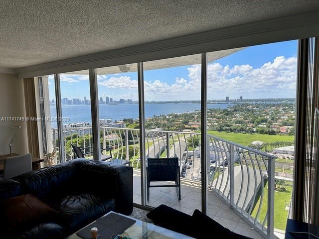 sunroom / solarium featuring a water view