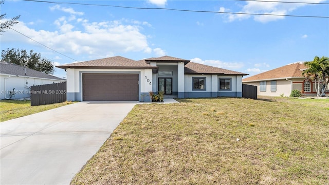 view of front facade with a garage and a front lawn