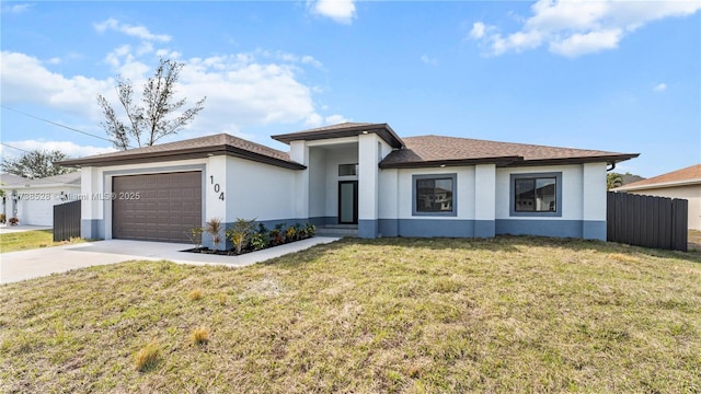 view of front of property with a garage and a front lawn