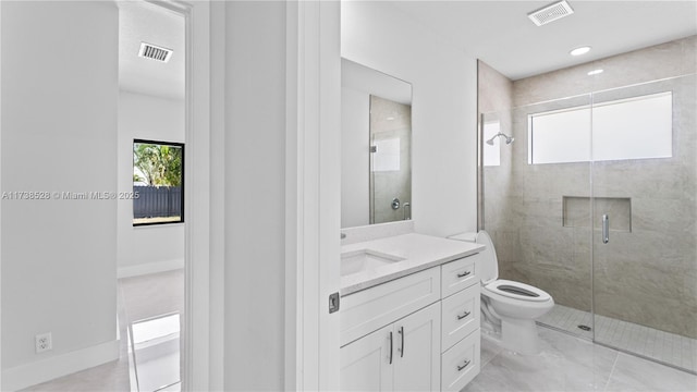 bathroom featuring a shower with door, vanity, and toilet