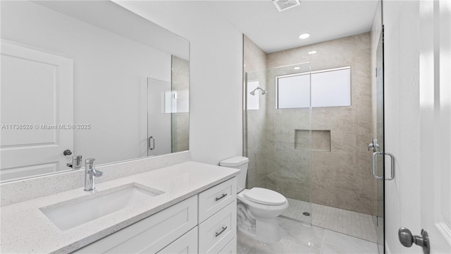 bathroom featuring vanity, toilet, and walk in shower