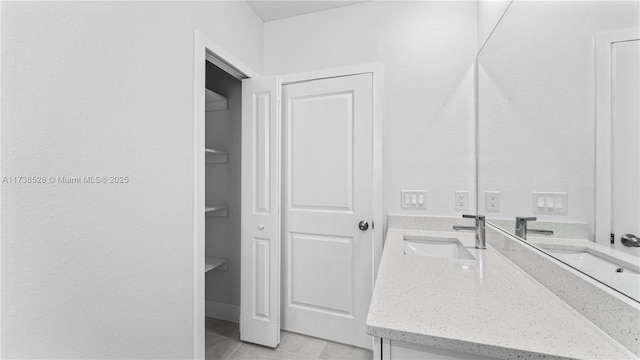 bathroom with vanity and tile patterned flooring