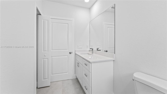 bathroom with tile patterned floors, vanity, and toilet