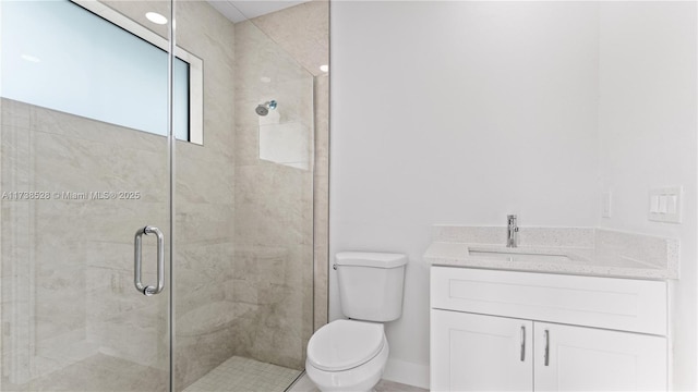 bathroom with vanity, a shower with shower door, and toilet