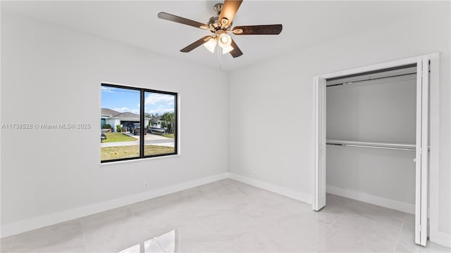 unfurnished bedroom with ceiling fan and a closet