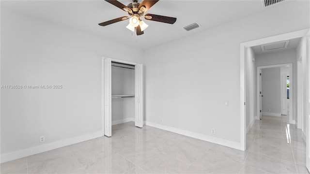 unfurnished bedroom with ceiling fan and a closet