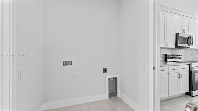 laundry room with electric dryer hookup, washer hookup, and light tile patterned floors