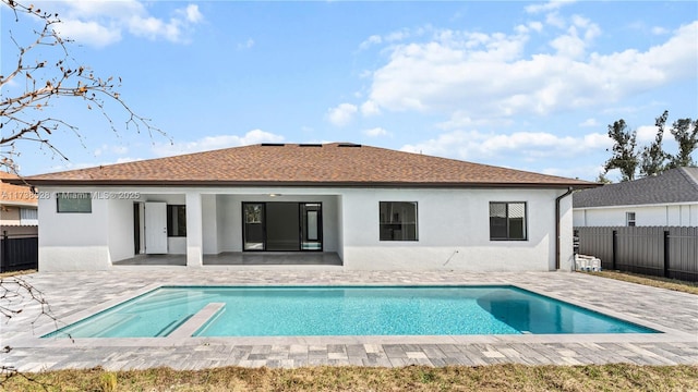 back of house featuring a fenced in pool and a patio