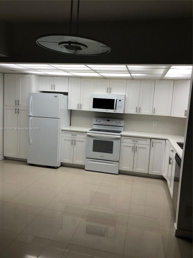 kitchen featuring white cabinetry and white appliances