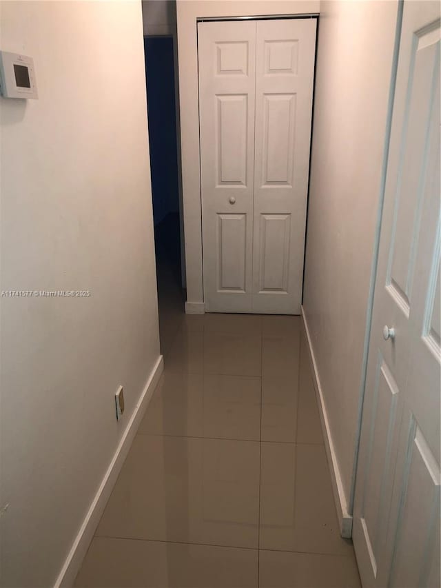 hallway with light tile patterned flooring