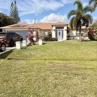 view of front facade with a front yard and an attached garage