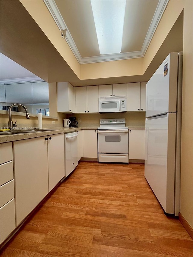 kitchen featuring ornamental molding, sink, white cabinets, and white appliances