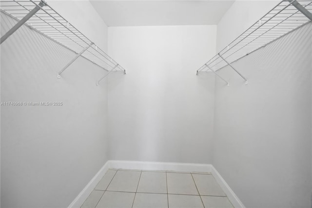 spacious closet with tile patterned floors