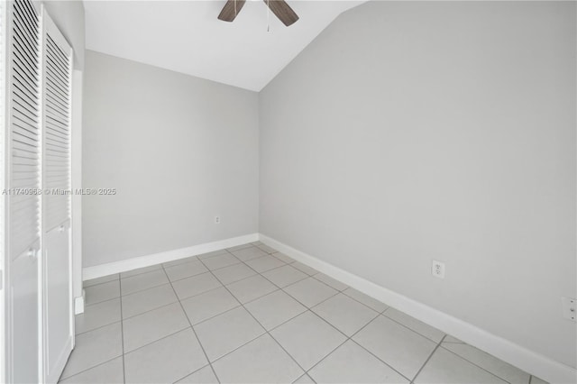 tiled empty room with ceiling fan and lofted ceiling