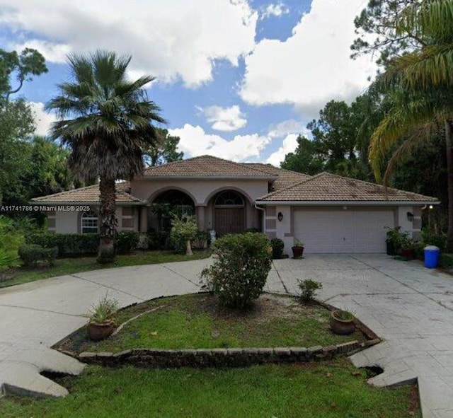 mediterranean / spanish house with a garage