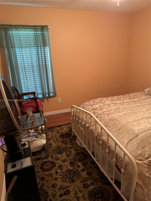 bedroom with hardwood / wood-style flooring