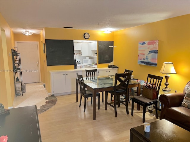 dining space featuring light wood-type flooring