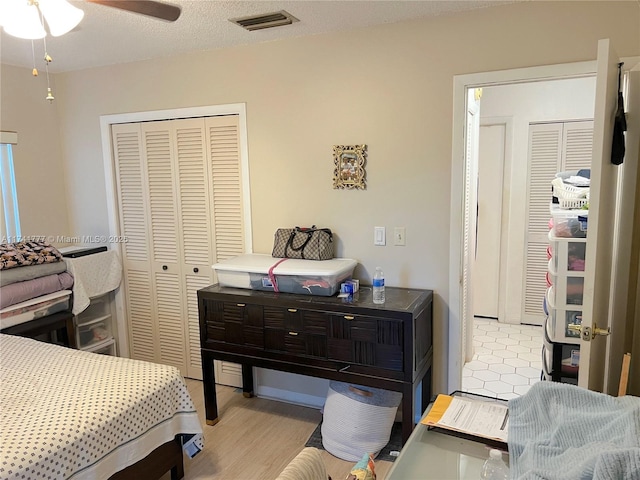 bedroom featuring a textured ceiling, light wood-type flooring, and a closet