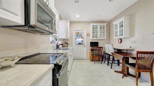 kitchen with white cabinetry, appliances with stainless steel finishes, and sink