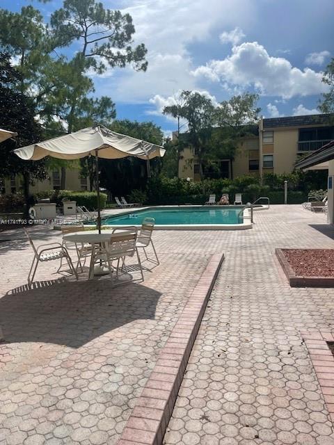 8429 Forest Hills Dr Unit 206, Coral Springs, FL 33065 - community pool with a patio