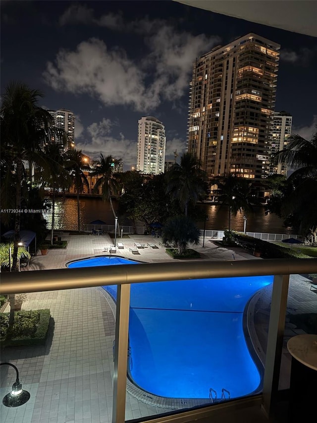 pool at twilight with a patio