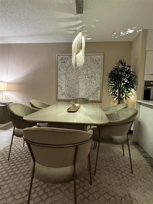 dining space with a textured ceiling