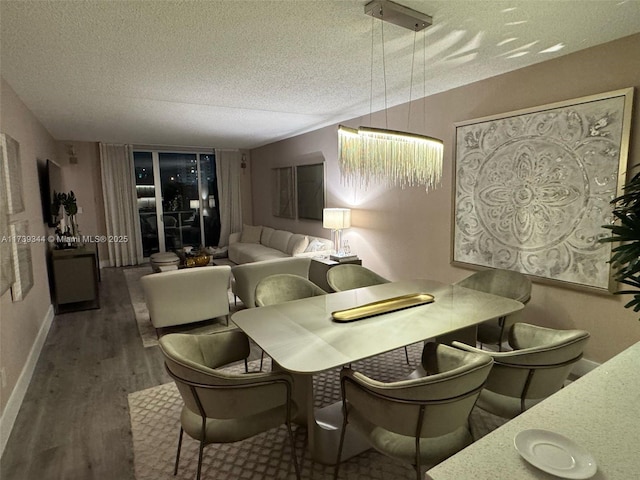 dining area with dark hardwood / wood-style floors and a textured ceiling