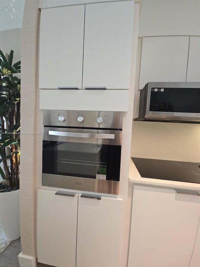 kitchen with stainless steel appliances and white cabinetry