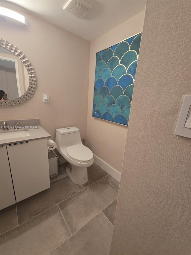 bathroom with vanity, tile patterned floors, and toilet