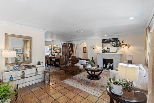 living room featuring an inviting chandelier, crown molding, and tile patterned floors