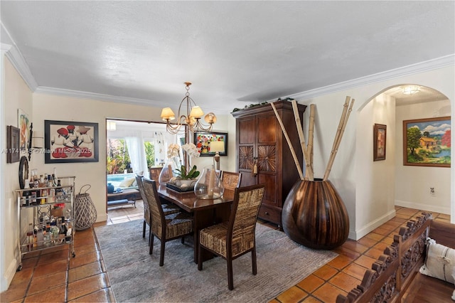 dining room with an inviting chandelier, tile patterned floors, and ornamental molding