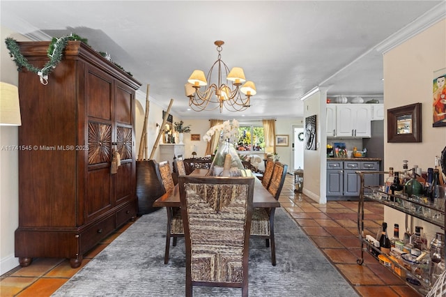 dining room with crown molding, dark tile patterned flooring, and an inviting chandelier