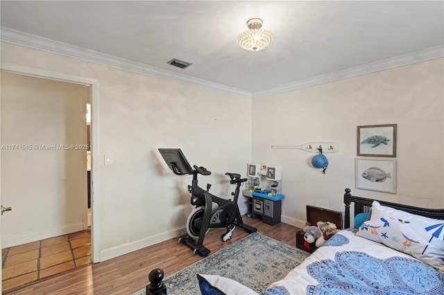 bedroom with crown molding and wood-type flooring