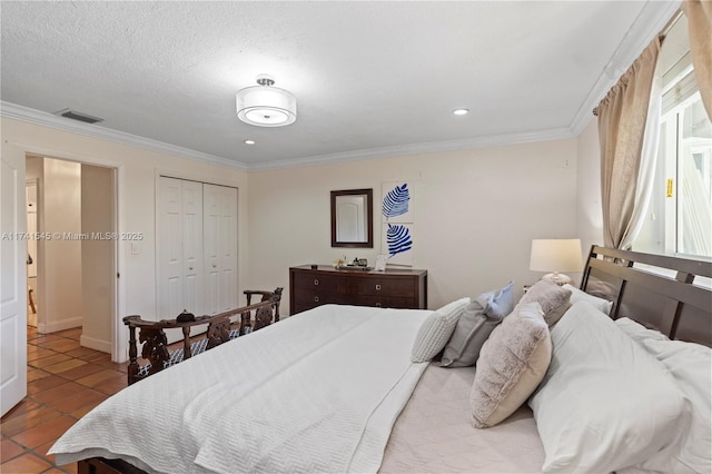 bedroom with ornamental molding, tile patterned floors, a closet, and a textured ceiling