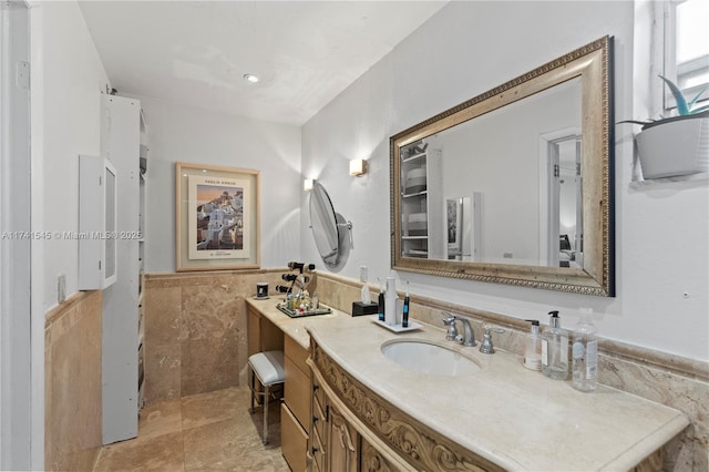 bathroom featuring tile walls and vanity